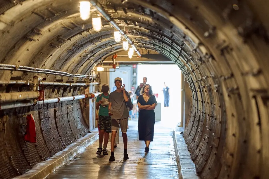 Visitors walking through a Diefenbunker tunnel