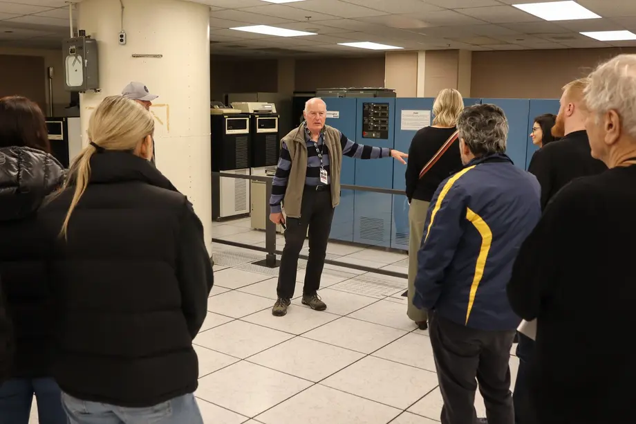 Visitors listening to a museum guide