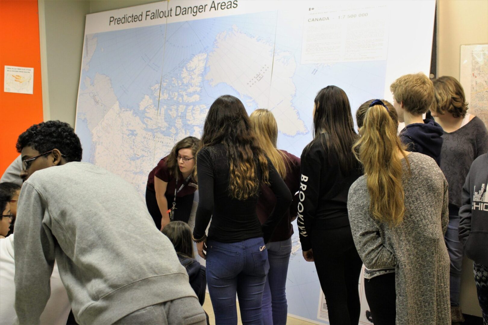 People observing a map at a climate change awards event.