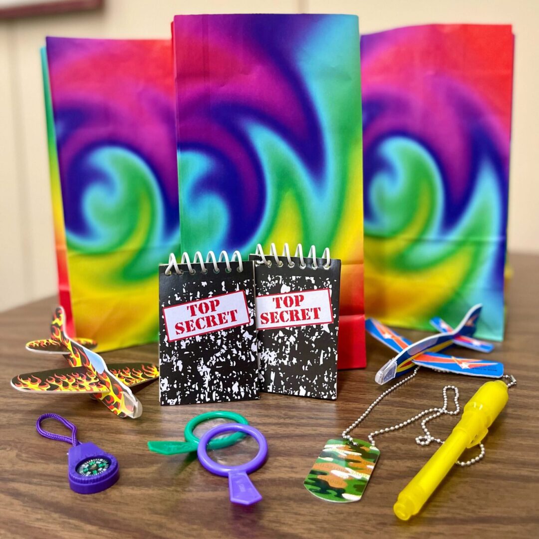 Colorful tie-dye kits with accessories and tools for crafting bracelets.