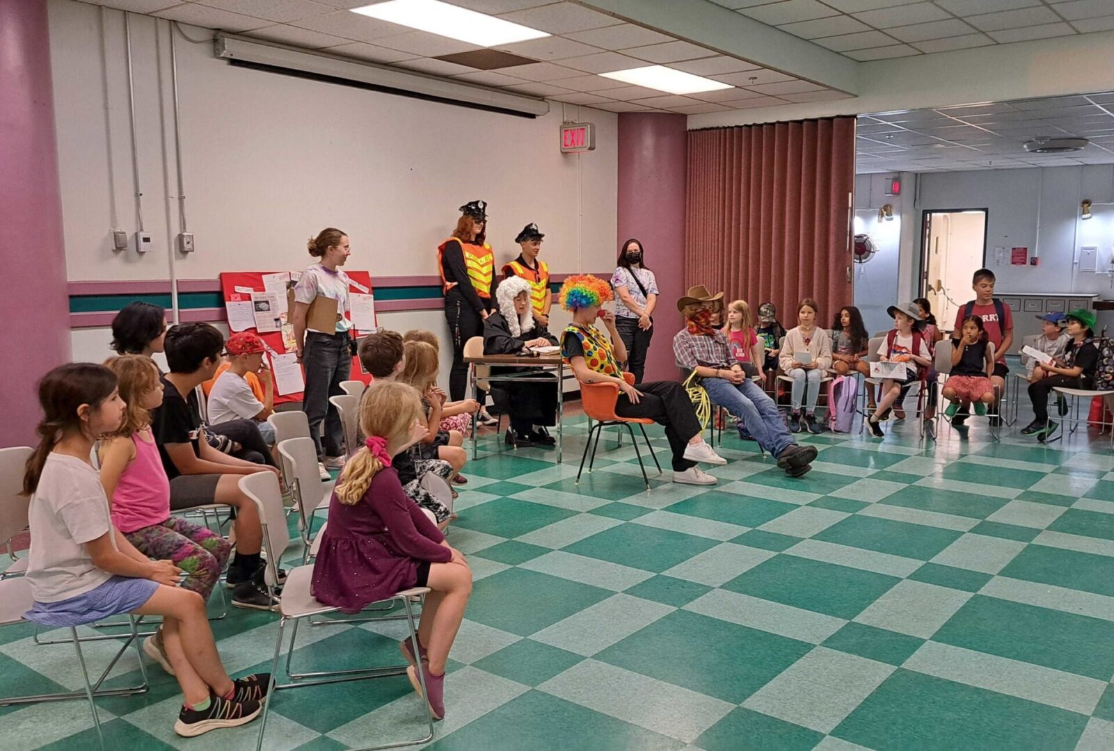 Children and adults engaged in a group activity in a classroom.