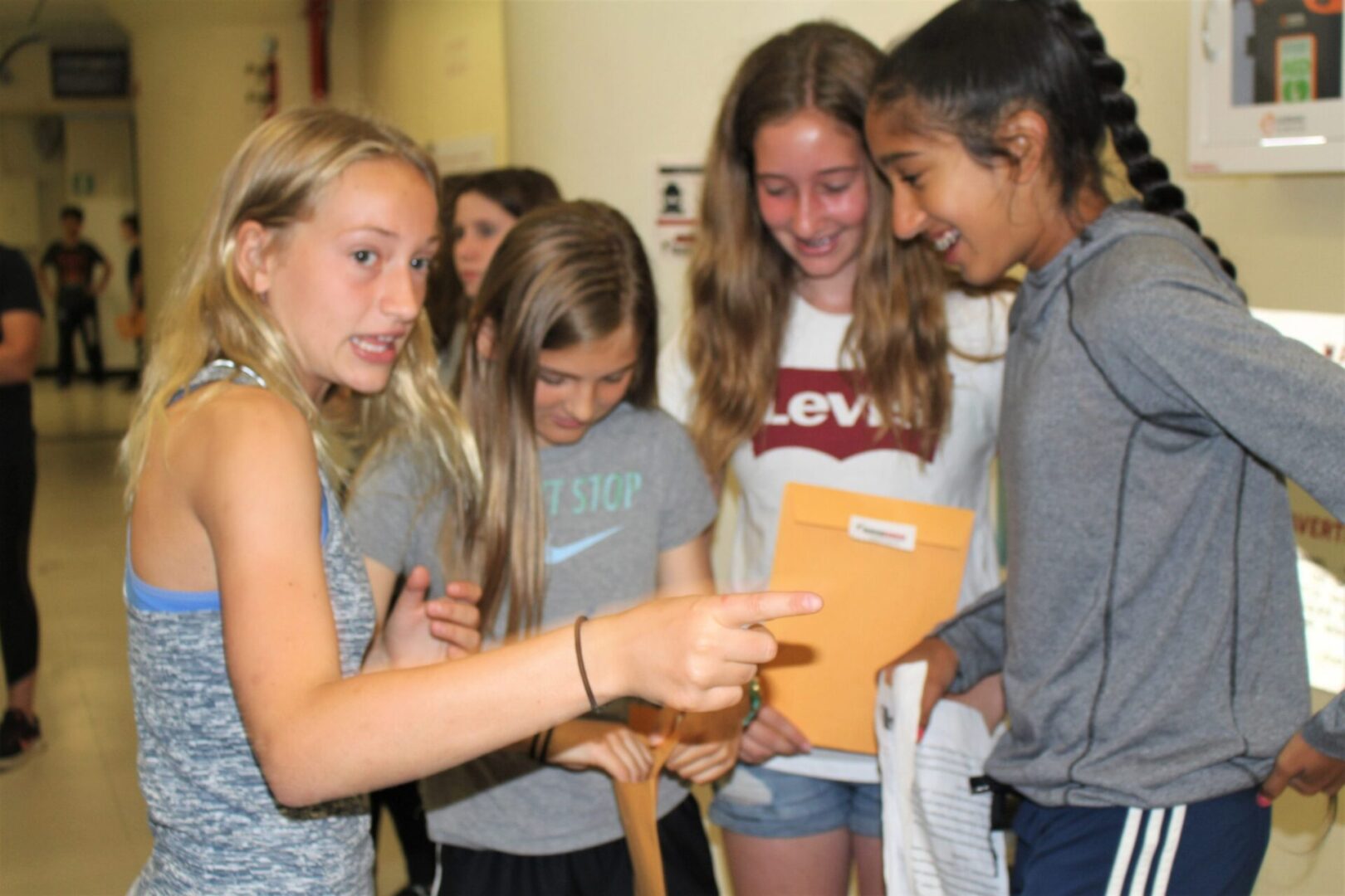 Girls excitedly examining a book together.