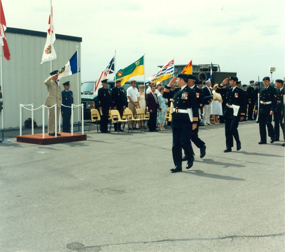 Military ceremony with officers in uniform and dignitaries on a platform.
