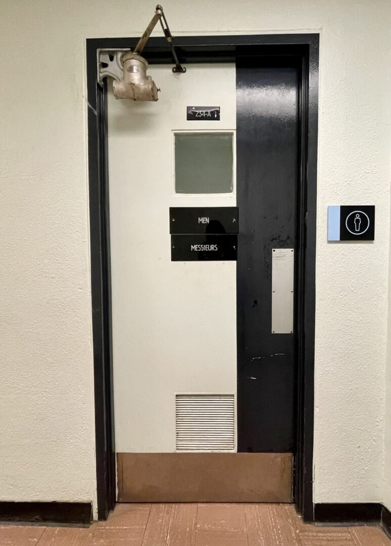 Elevator door with a disabled access sign on the wall.