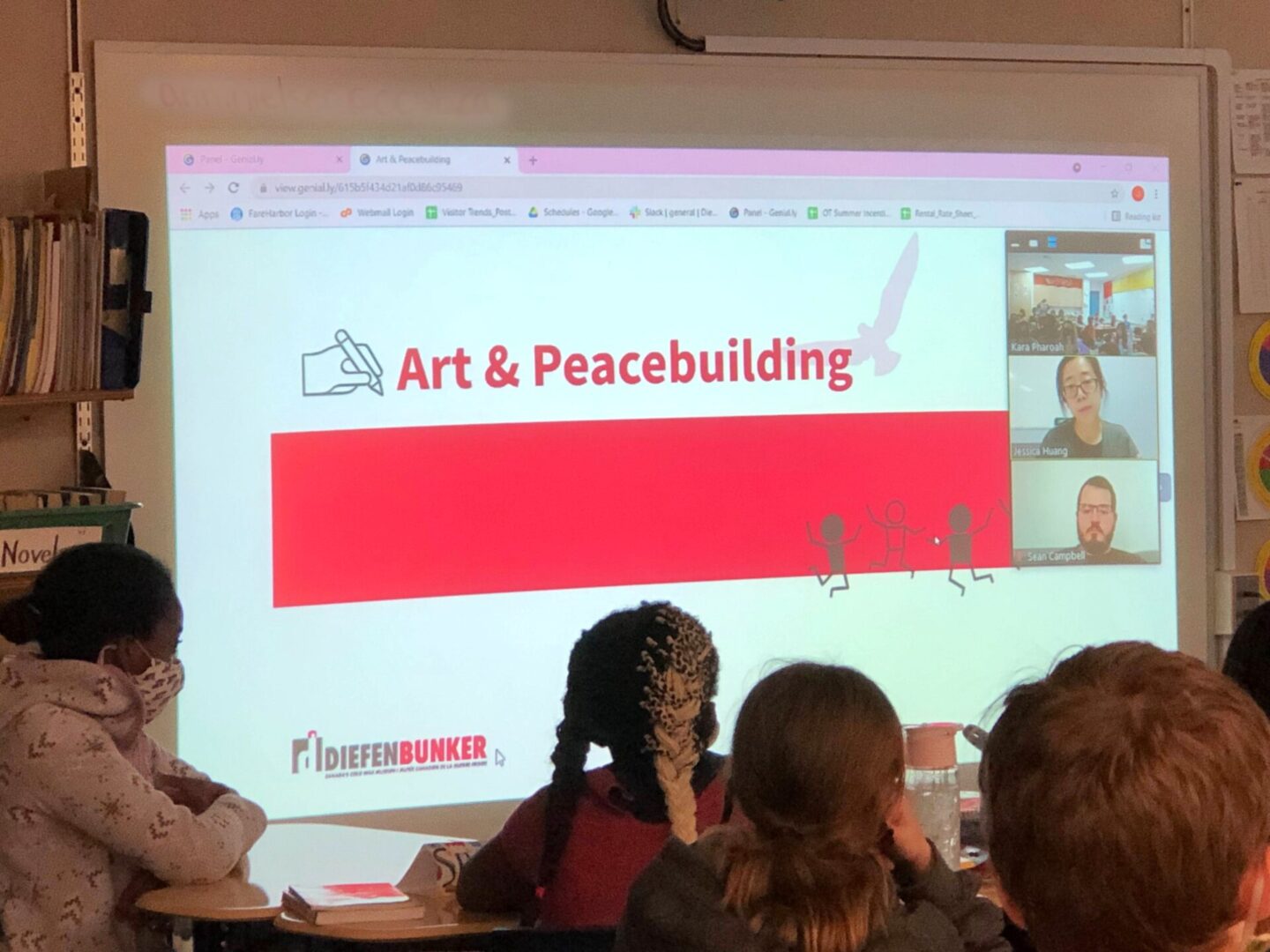 Audience watching a presentation titled 'Art & Peacebuilding'.