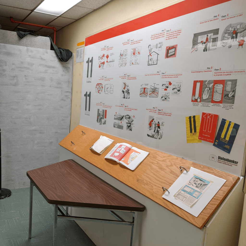 Exhibition display of design concepts and booklets on angled boards in a room.
