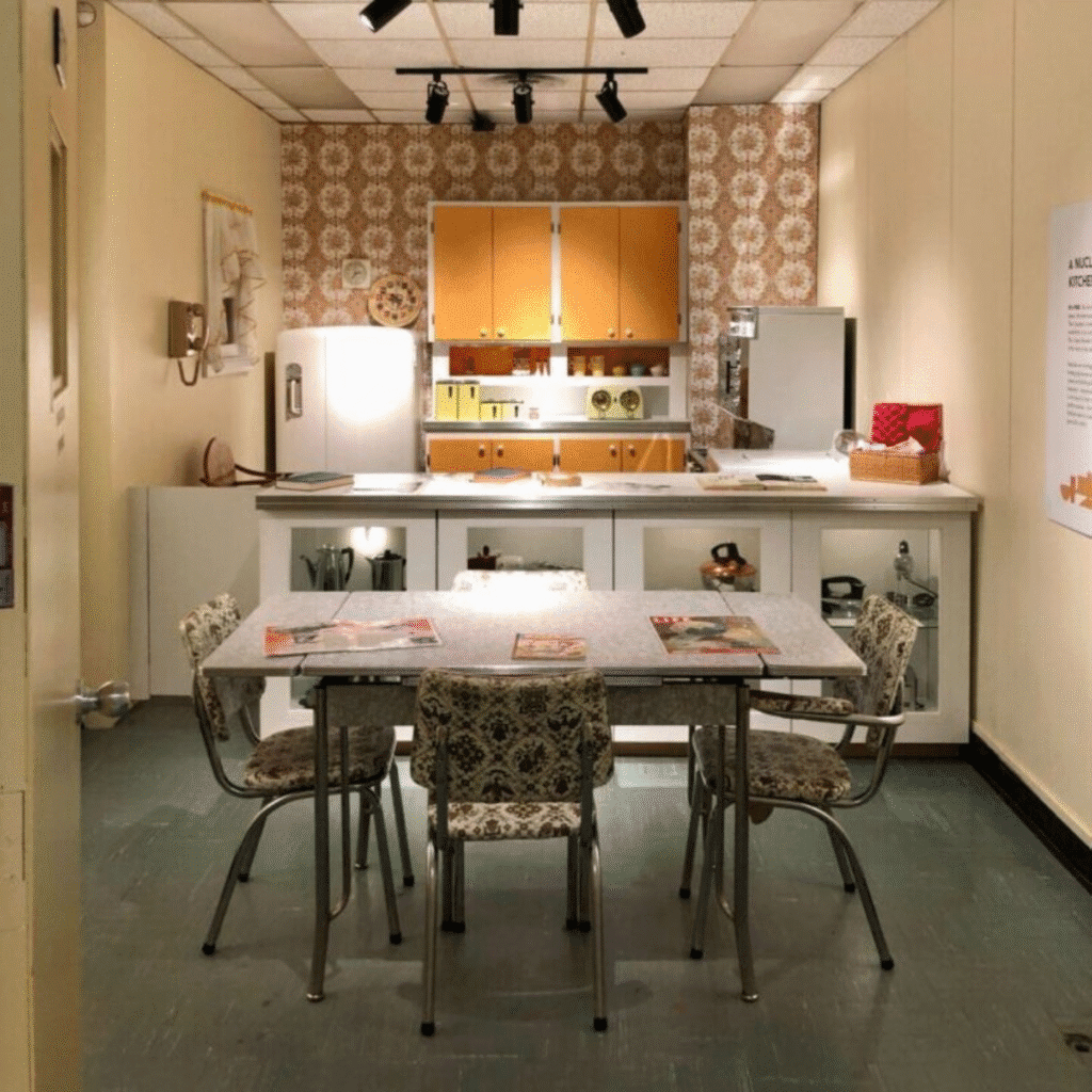 Cozy retro kitchen with patterned wallpaper and dining table.