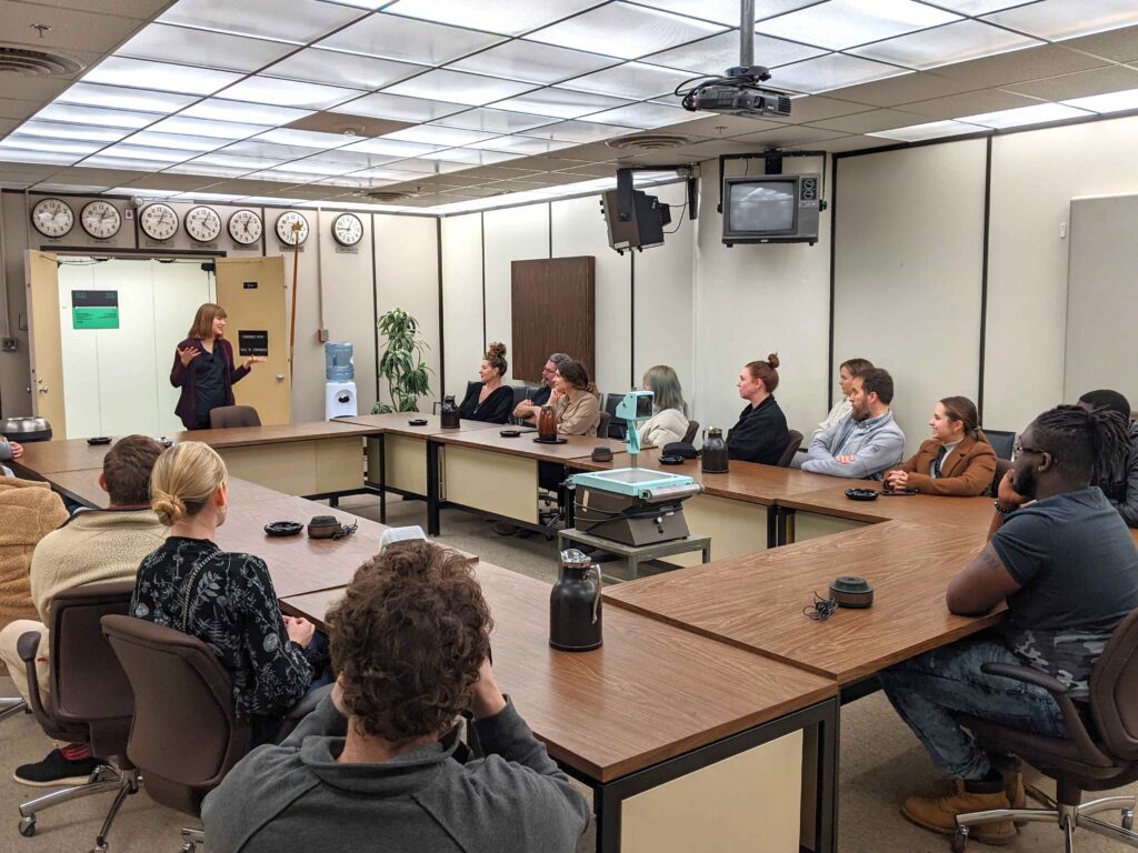 People attending a presentation in a conference room.