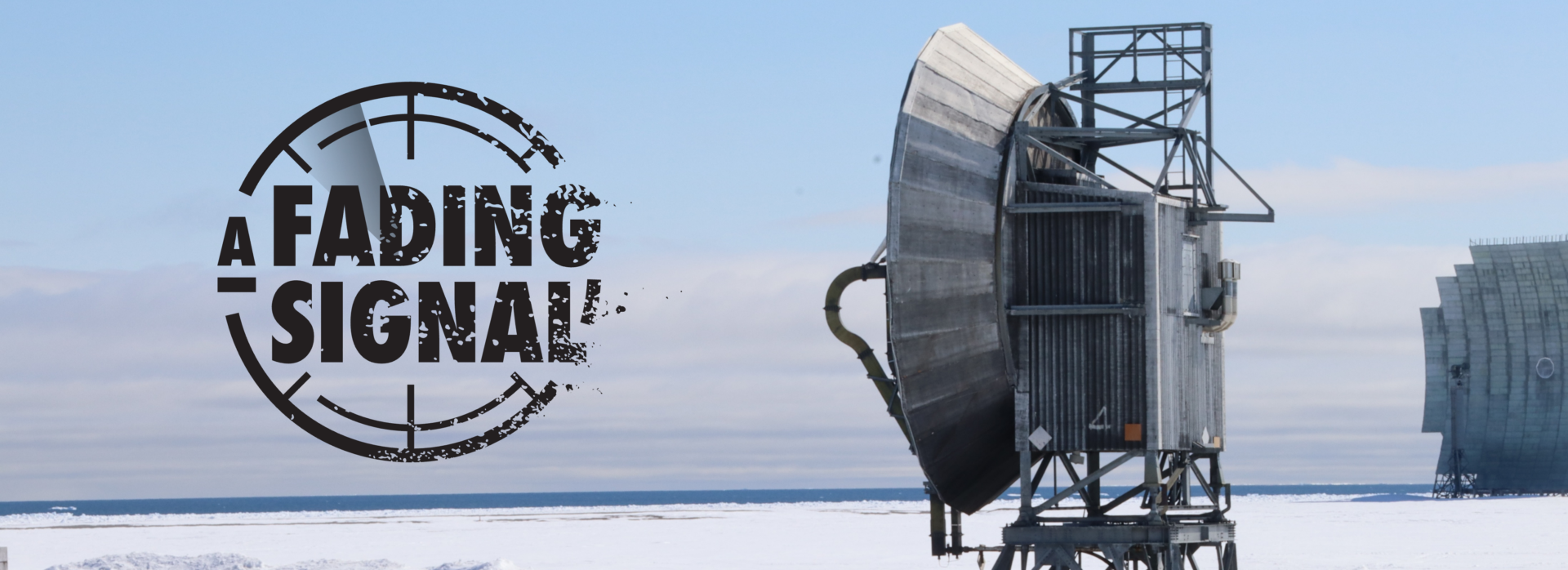 Large grey parabolic antennae set in a snow-covered area.