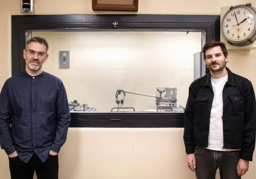 Jean-Sébastien Côté and Julien Morissette stand in the historic CBC Radio Broadcasting Studio at the Diefenbunker: Canada's Cold War Museum.