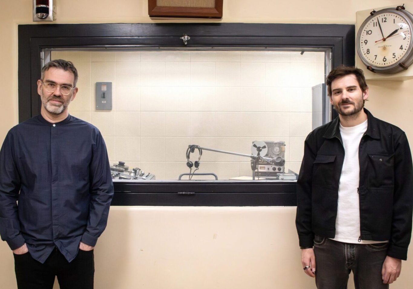 Jean-Sébastien Côté and Julien Morissette stand in the historic CBC Radio Broadcasting Studio at the Diefenbunker: Canada's Cold War Museum.