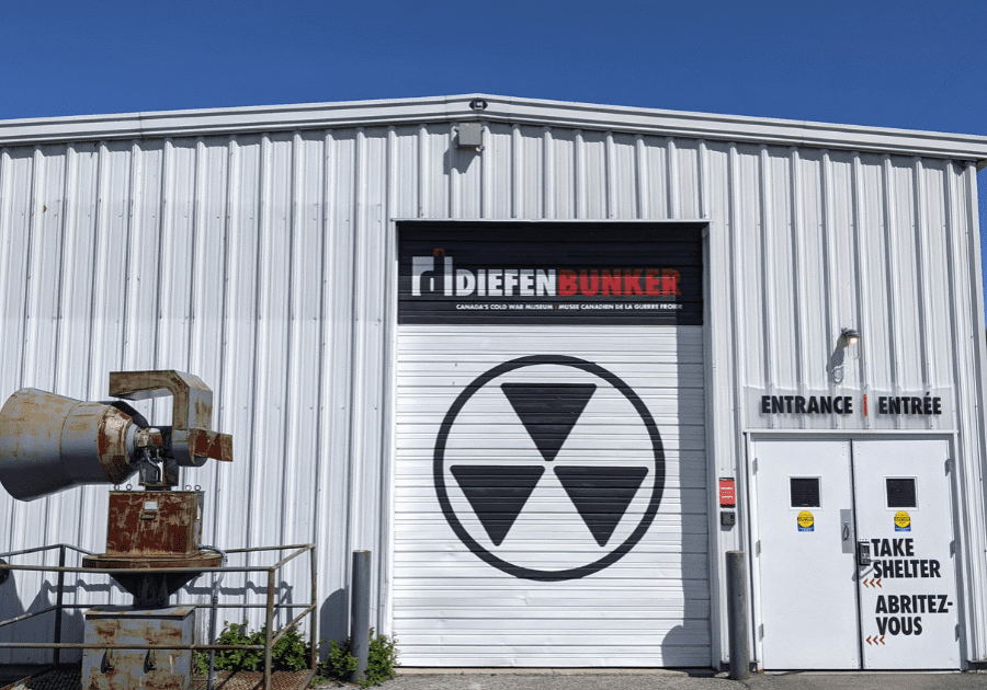 Exterior of a Difleen Lumber building with a large garage door featuring a radiation symbol.